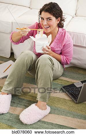 Mixed race woman eating take-out View Large Photo Image Stock Image - Mixed race woman eating take-out. Fotosearch