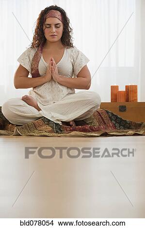 Picture - Mixed race woman practicing yoga. Fotosearch