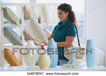 Mixed race woman shopping for pillows View Large Photo Image Stock Image - Mixed race woman shopping for pillows. Fotosearch