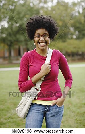 Stock Photo - Mixed race woman smiling in park. Fotosearch