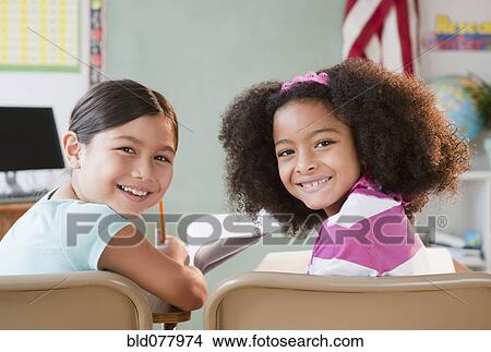 School girls smiling in classroom View Large Photo Image Picture - School girls smiling in classroom. Fotosearch