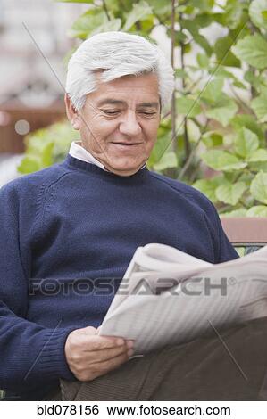 Senior Hispanic man reading newspaper View Large Photo Image Stock Photograph - Senior Hispanic man reading newspaper. Fotosearch