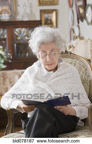Senior Hispanic woman reading book View Large Photo Image Stock Photo - Senior Hispanic woman reading book. Fotosearch