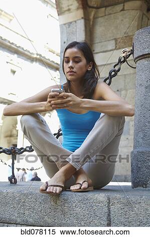 Thai woman text messaging on cell phone View Large Photo Image Stock Photography - Thai woman text messaging on cell phone. Fotosearch