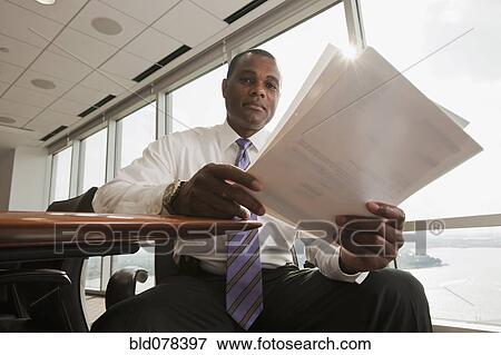 African American businessman reviewing paperwork View Large Photo Image Stock Photo - African American businessman reviewing paperwork. Fotosearch
