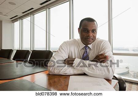 African American businessman sitting in conference room View Large Photo Image Stock Photo - African American businessman sitting in conference room. Fotosearch