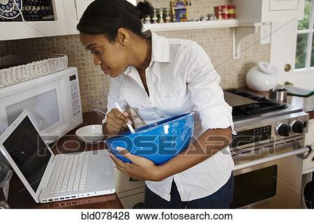African woman following internet recipe View Large Photo Image Stock Photo - African woman following internet recipe. Fotosearch