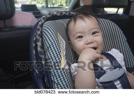 Stock Image - Chinese baby in car seat. Fotosearch
