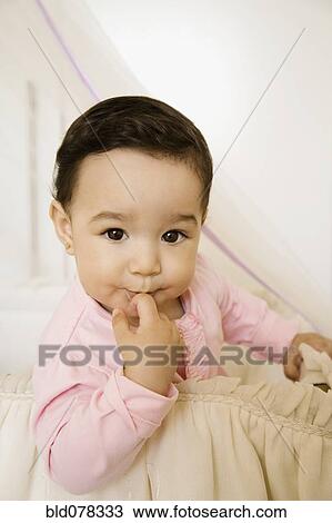 Curious Hispanic baby girl View Large Photo Image Stock Image - Curious Hispanic baby girl. Fotosearch