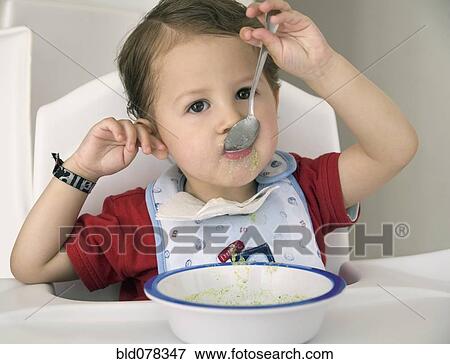 Stock Photo - Hispanic boy eating cereal. Fotosearch