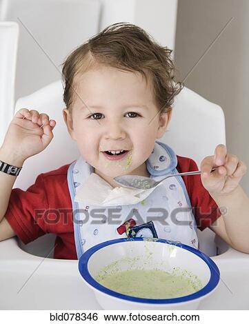 Stock Photograph - Hispanic boy eating cereal. Fotosearch