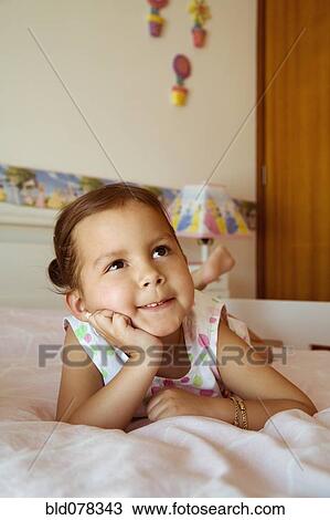 Hispanic girl daydreaming on bed View Large Photo Image Stock Image - Hispanic girl daydreaming on bed. Fotosearch