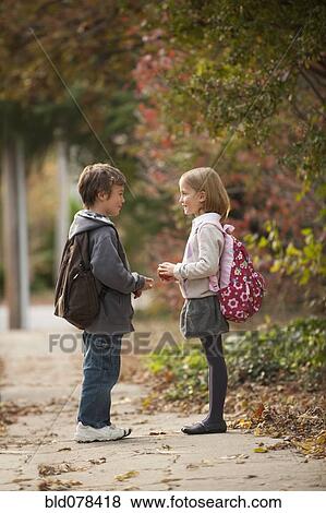 Stock Photo - Mixed race brother and sister walking on sidewalk. Fotosearch
