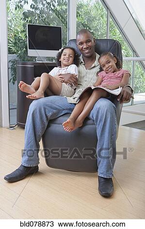 African American father holding daughters on his lap View Large Photo Image Stock Image - African American father holding daughters on his lap. Fotosearch
