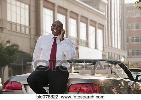 Black businessman talking on cell phone outdoors View Large Photo Image Stock Image - Black businessman talking on cell phone outdoors. Fotosearch