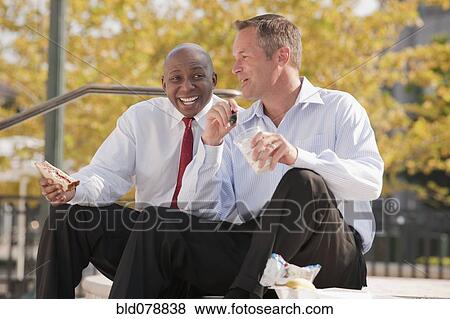 Businessmen eating lunch on steps View Large Photo Image Stock Photo - Businessmen eating lunch on steps. Fotosearch