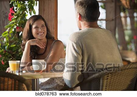 Stock Image - Caucasian couple eating in restaurant. Fotosearch