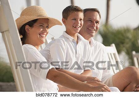Stock Image - Caucasian family laughing together. Fotosearch