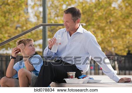 Caucasian father and son eating on steps View Large Photo Image Picture - Caucasian father and son eating on steps. Fotosearch