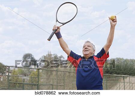 Excited senior Hispanic man playing tennis View Large Photo Image Stock Image - Excited senior Hispanic man playing tennis. Fotosearch