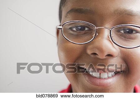 Stock Photo - Hispanic boy in eyeglasses smiling. Fotosearch