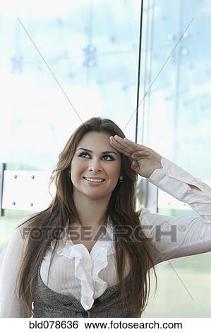 Stock Photograph - Hispanic businesswoman saluting. Fotosearch
