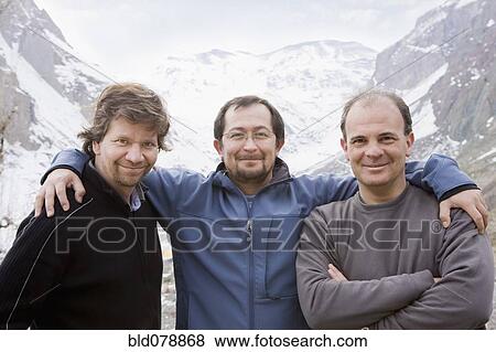 Hispanic friends hugging in snowy mountain valley View Large Photo Image Stock Photo - Hispanic friends hugging in snowy mountain valley. Fotosearch