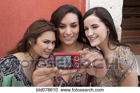 Hispanic friends taking self-portrait View Large Photo Image Stock Image - Hispanic friends taking self-portrait. Fotosearch