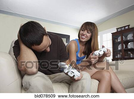 Stock Photo - Hispanic husband and wife playing video game. Fotosearch