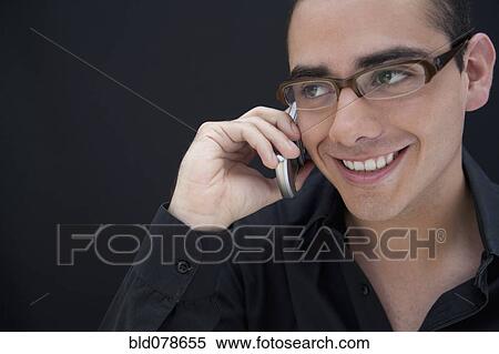 Hispanic man in eyeglasses talking on cell phone View Large Photo Image Stock Photography - Hispanic man in eyeglasses talking on cell phone. Fotosearch