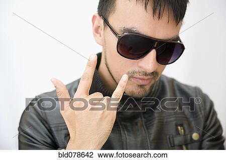 Hispanic man in sunglasses and leather coat gesturing View Large Photo Image Stock Image - Hispanic man in sunglasses and leather coat gesturing. Fotosearch
