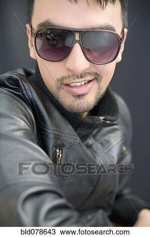 Hispanic man in sunglasses and leather coat View Large Photo Image Stock Image - Hispanic man in sunglasses and leather coat. Fotosearch