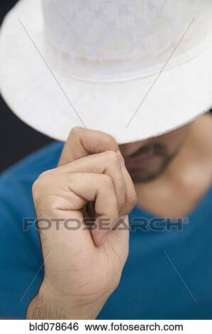 Stock Photograph - Hispanic man in white fedora hat. Fotosearch