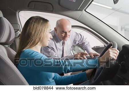 Picture - Hispanic woman shopping for new car. Fotosearch