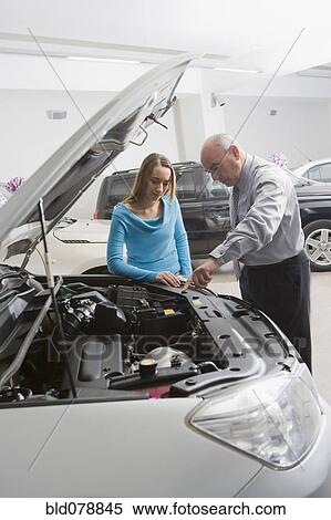 Stock Photography - Hispanic woman shopping for new car. Fotosearch