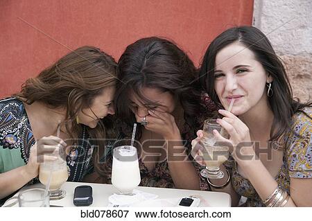 Hispanic women laughing and drinking at cafe View Large Photo Image Stock Photo - Hispanic women laughing and drinking at cafe. Fotosearch