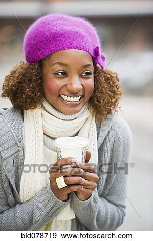Stock Photo - Mixed race woman drinking coffee. Fotosearch