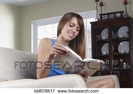 Stock Photo - Mixed race woman reading book. Fotosearch
