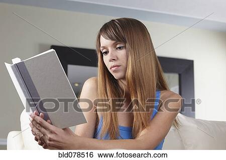 Stock Photograph - Mixed race woman reading book. Fotosearch