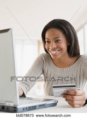 Mixed race woman shopping online with credit card View Large Photo Image Stock Image - Mixed race woman shopping online with credit card. Fotosearch