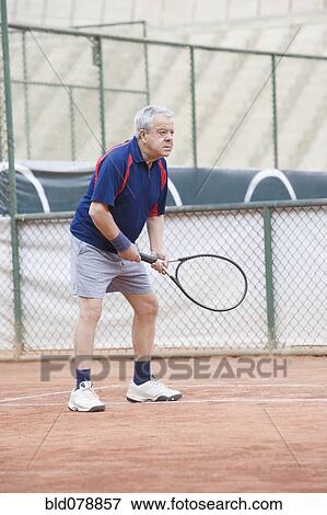 Senior Hispanic man playing tennis View Large Photo Image Stock Photo - Senior Hispanic man playing tennis. Fotosearch