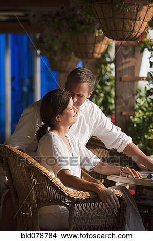 Picture - Smiling Caucasian couple in restaurant. Fotosearch