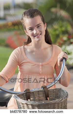 Smiling Caucasian girl on bicycle View Large Photo Image Stock Image - Smiling Caucasian girl on bicycle. Fotosearch