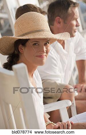 Smiling Caucasian woman sitting with family View Large Photo Image Picture - Smiling Caucasian woman sitting with family. Fotosearch