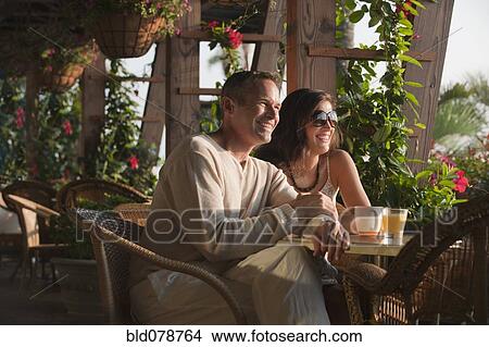 Picture - Smiling couple eating in restaurant. Fotosearch