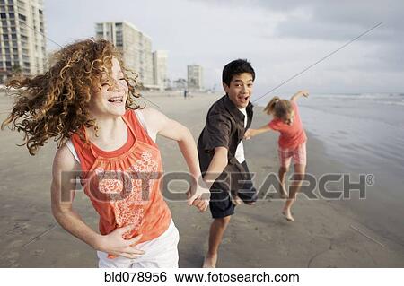 Friends playing on beach View Large Photo Image Stock Photograph - Friends playing on beach. Fotosearch