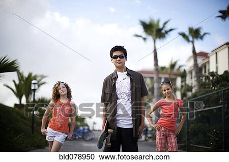 Friends walking along urban sidewalk View Large Photo Image Stock Image - Friends walking along urban sidewalk. Fotosearch