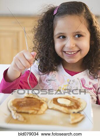 Hispanic girl eating pancakes View Large Photo Image Picture - Hispanic girl eating pancakes. Fotosearch