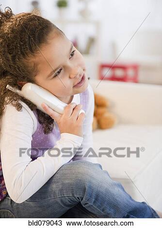 Hispanic girl talking on telephone View Large Photo Image Stock Image - Hispanic girl talking on telephone. Fotosearch