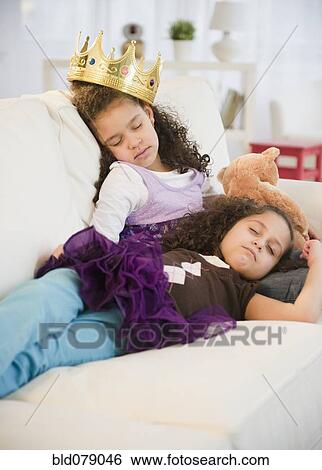 Hispanic sisters in costumes sleeping on couch View Large Photo Image Stock Photograph - Hispanic sisters in costumes sleeping on couch. Fotosearch